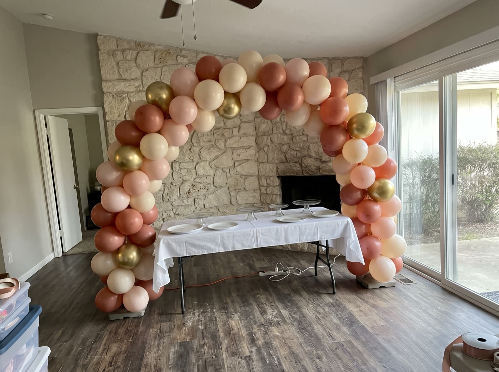 Organic balloon arch in terracotta, blush and cream over a dessert table at an Austin birthday party